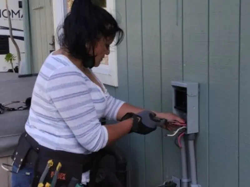 Licensed electrician wiring an exterior subpanel in Purcell