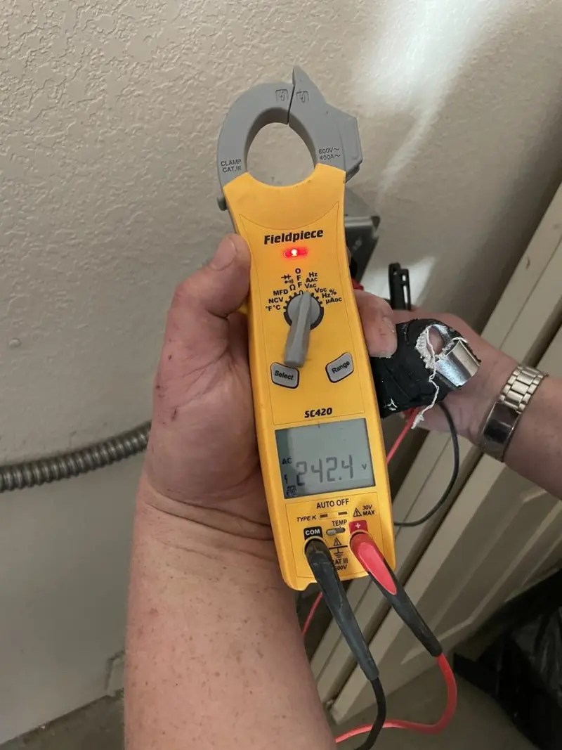 Voltage testing with clamp meter during Electrical Installation Services in Purcell